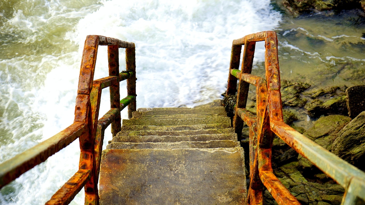 Image of rusty stairs into water