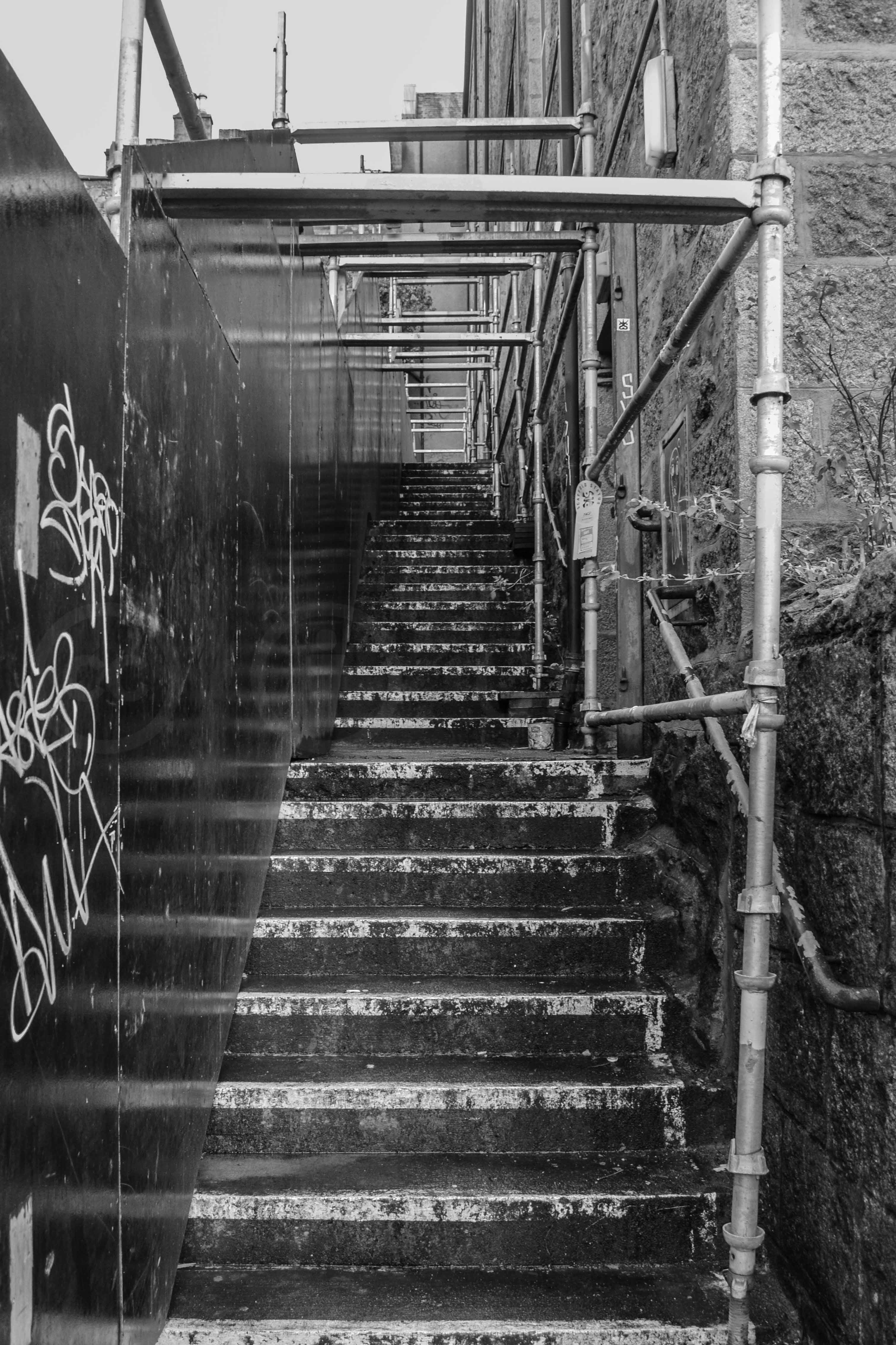 A dirty set of stairs with scaffolding