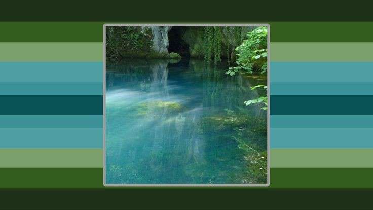 thisimageic flag. the image is that of a crystal clear lake that leads into a cave. the lake is framed by green foliage