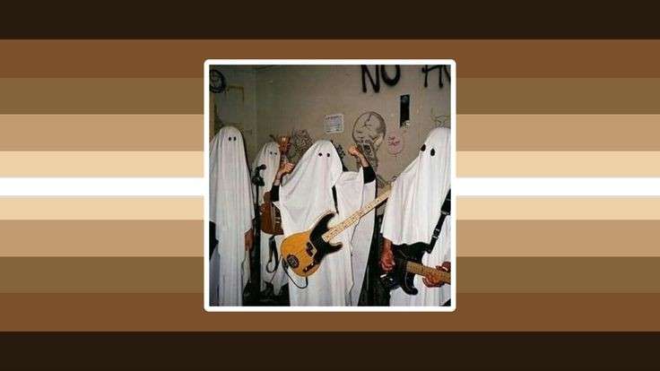 thisimageic flag. the image is a group of people dressed up in ghost outfits (white sheets with eye holes), holding guitars in their hands. it looks like they're apart of a band