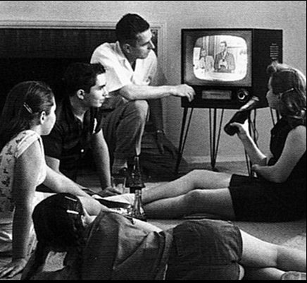 An American family watching television at home in the 1950s