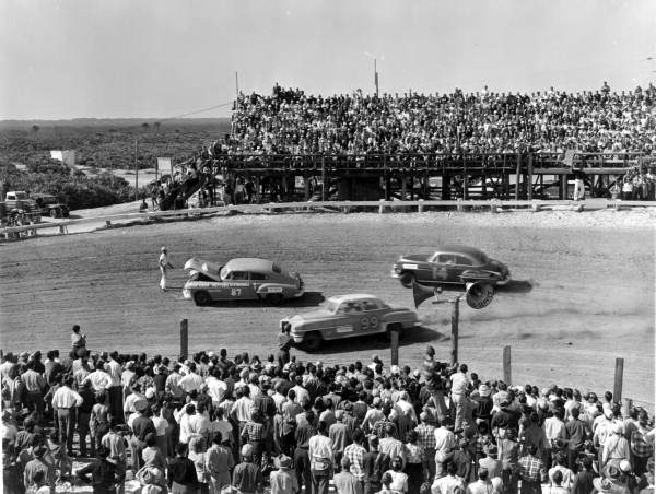 Drivers swerve around a stalled car on the Daytona beach-and-road course, February 1952 — the rough-and-ready early NASCAR world that Darlington's paved Southern 500 began to change