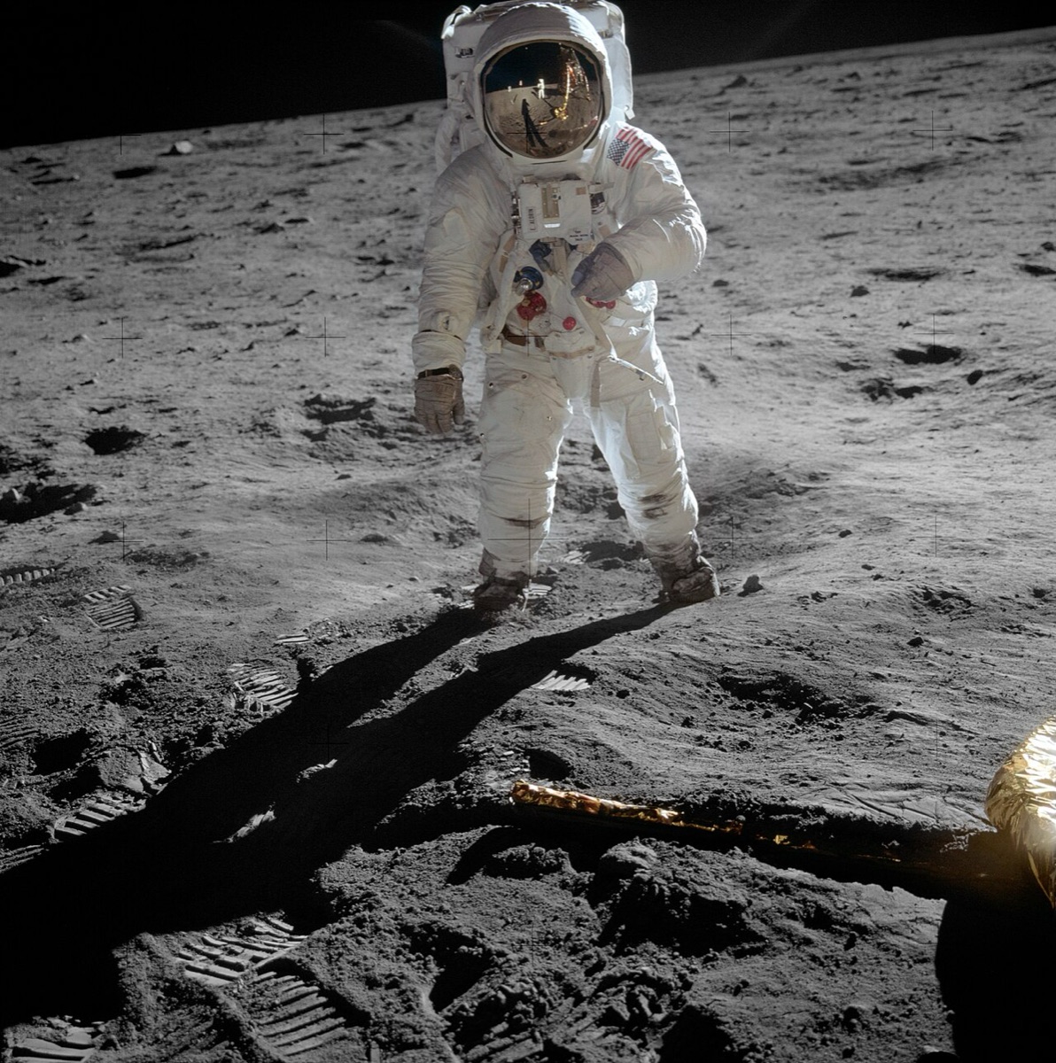 Buzz Aldrin on the lunar surface, with the photographer reflected in his visor