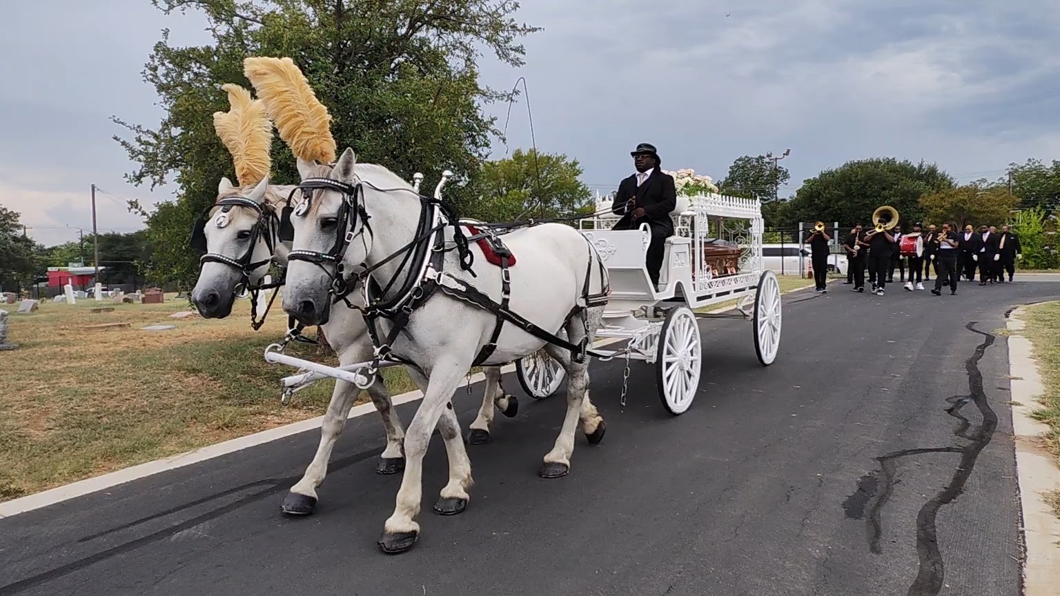 Jazz funeral procession with horse-drawn hearse at Evergreen Cemetery Austin Texas