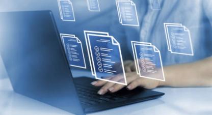 Open laptop and documentation photo