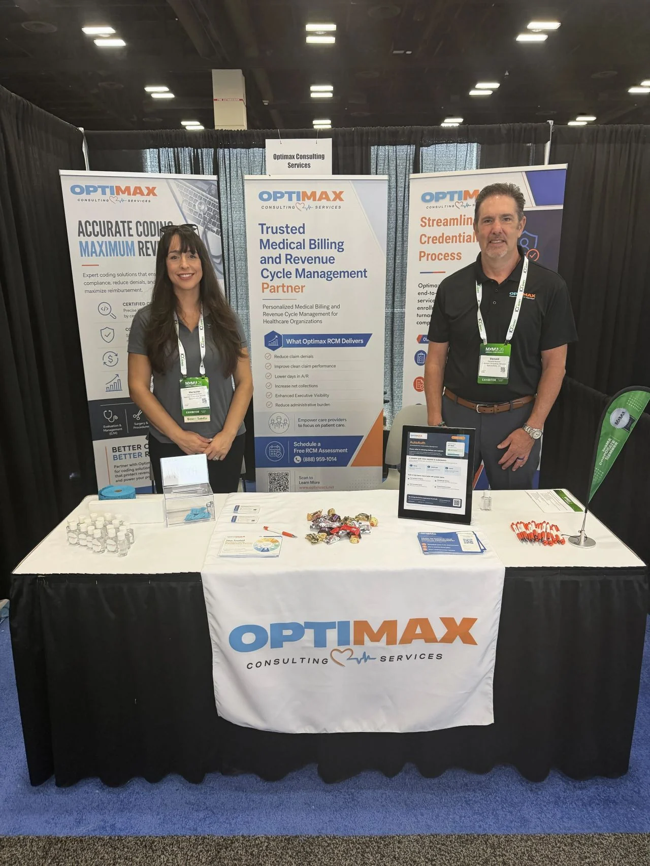 Optimax team members at their healthcare conference booth.