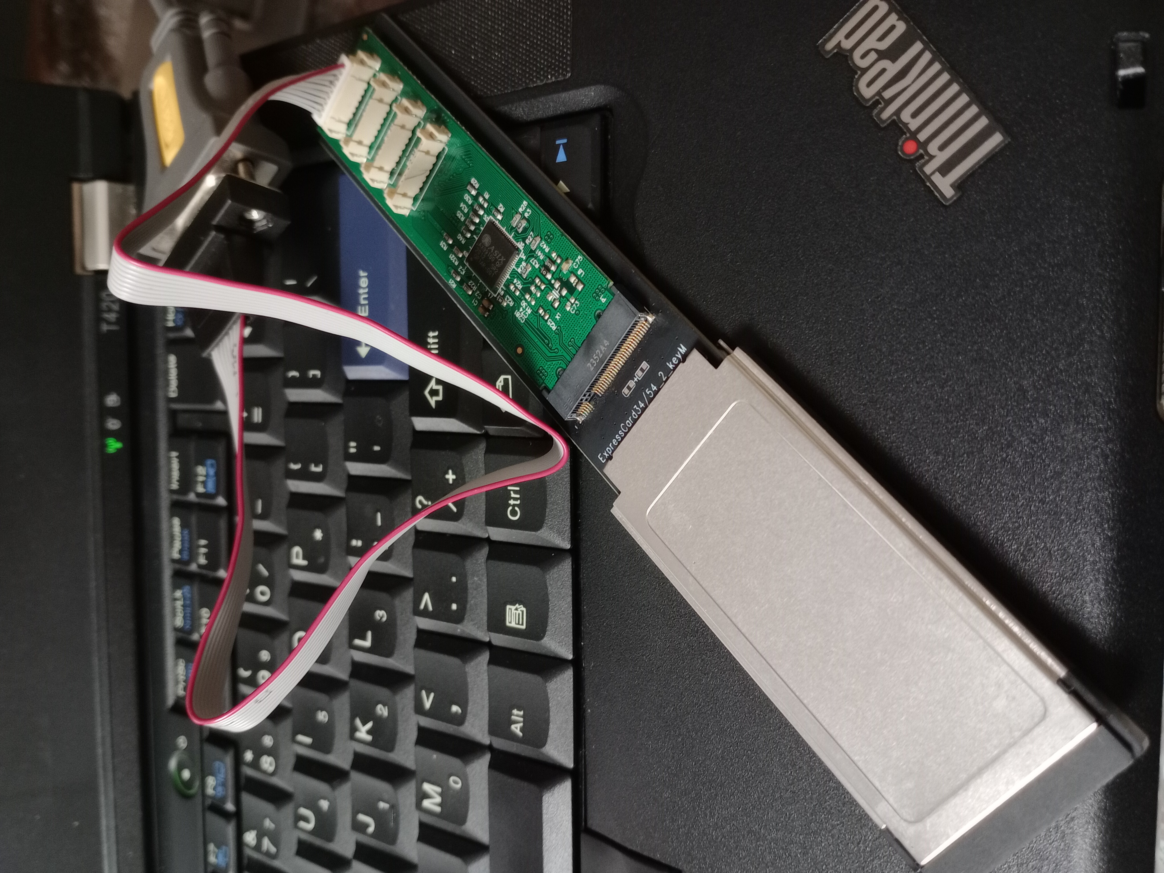 An AX99100 M.2 serial bridge connected to a cardbus adapter, which is then plugged into the
laptop's expresscard slot to enable serial debugging