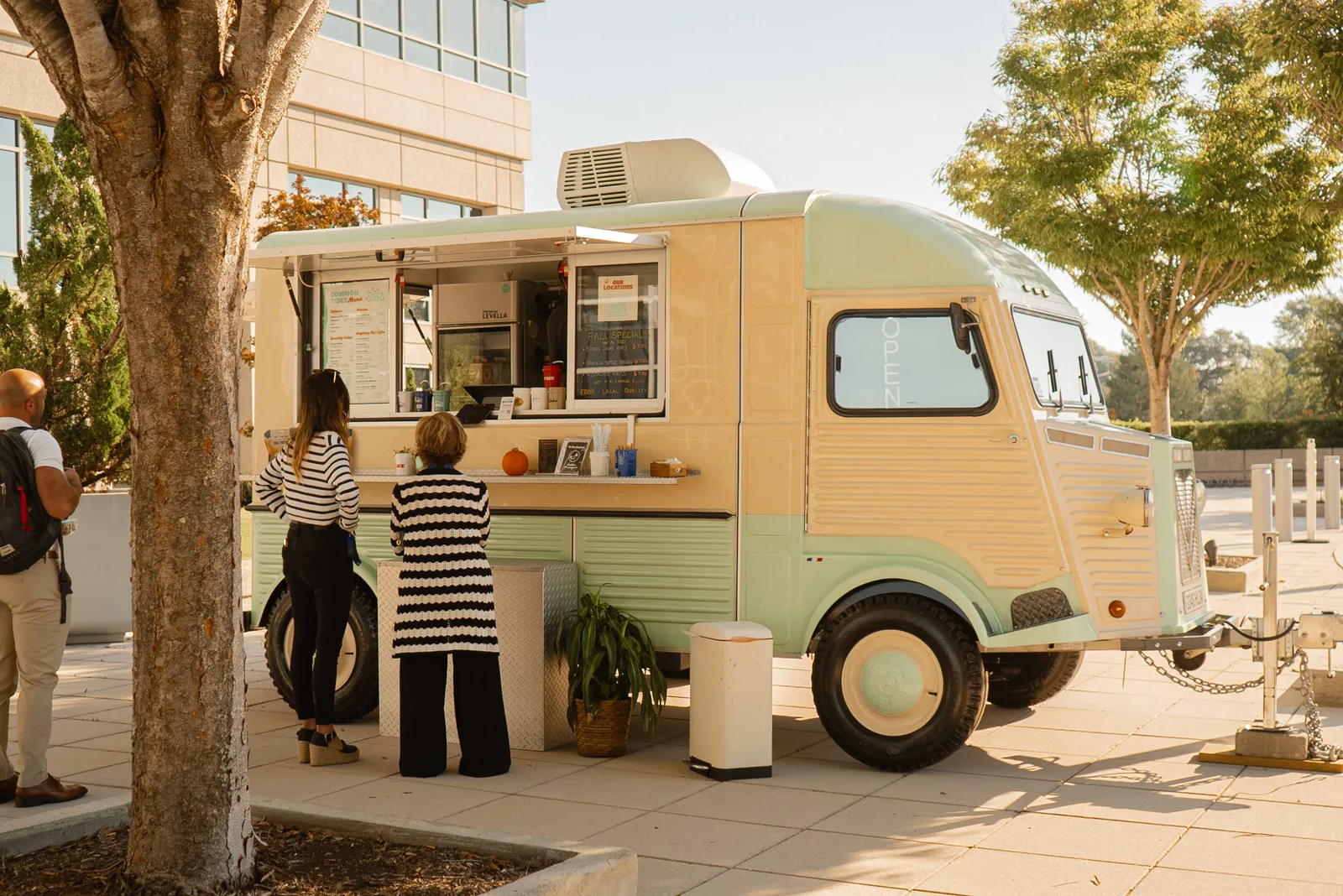 The Common Tides coffee trailer parked under the trees at Skyline Center in downtown Wilmington NC with customers at the window