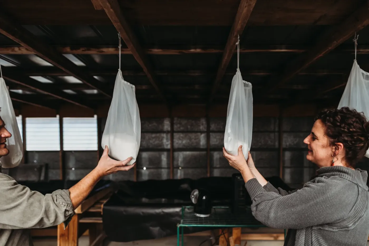 Sea Love Sea Salt founders Jeanette Philips and Jason Zombron hanging cheesecloth bags of freshly harvested sea salt to drip dry