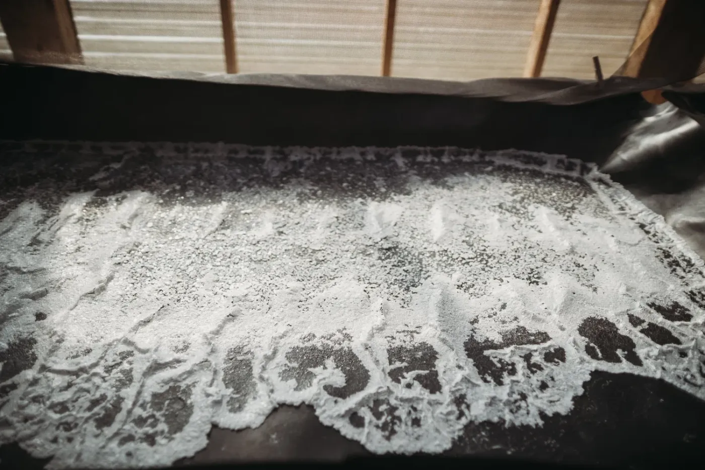 Sea salt crystals forming in a solar evaporation tray inside the Sea Love salthouse in Burgaw NC