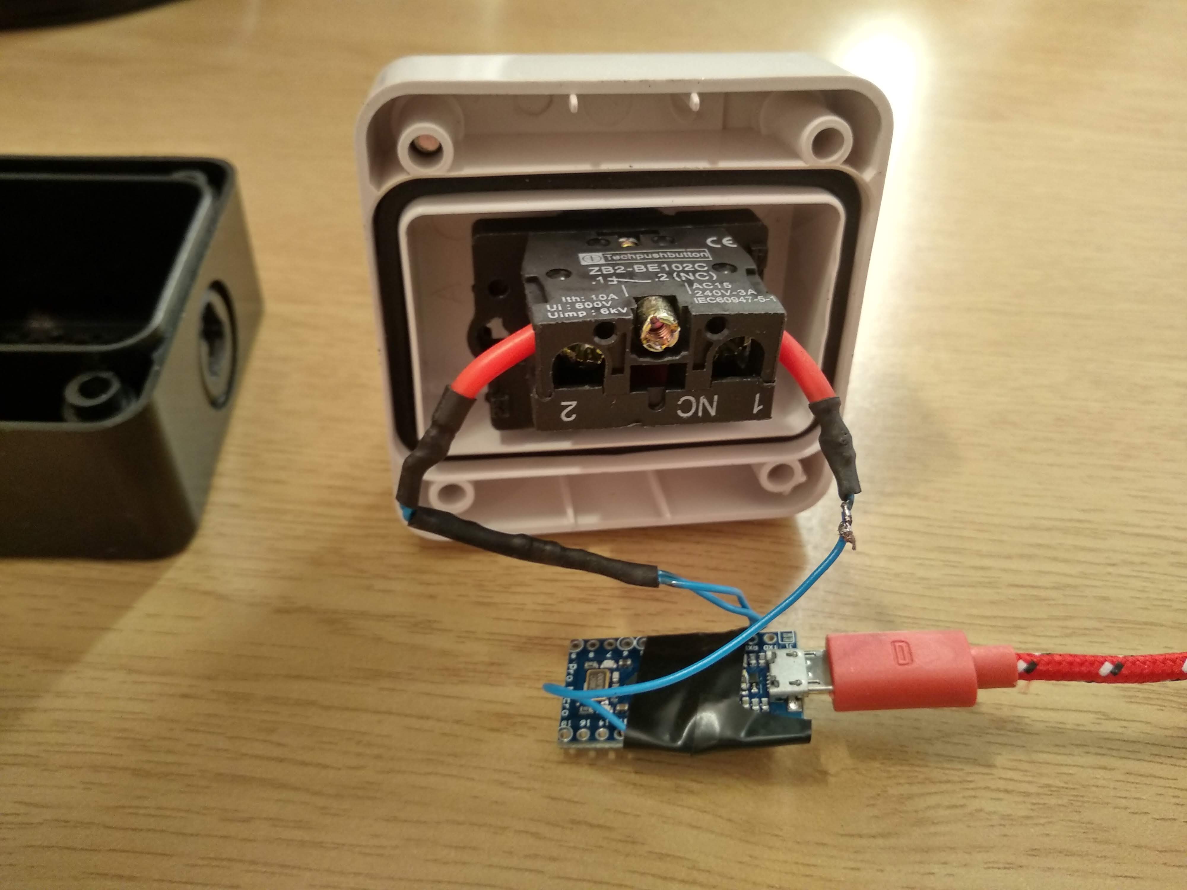 Photo of the inside of the emergency stop button with wiring and arduino visible