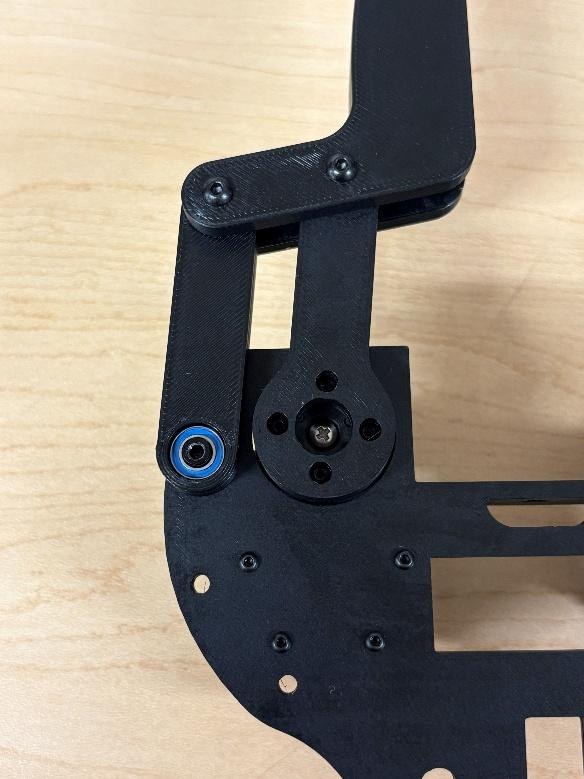 Close-up of the crank fastened to the servo horn, bearing visible