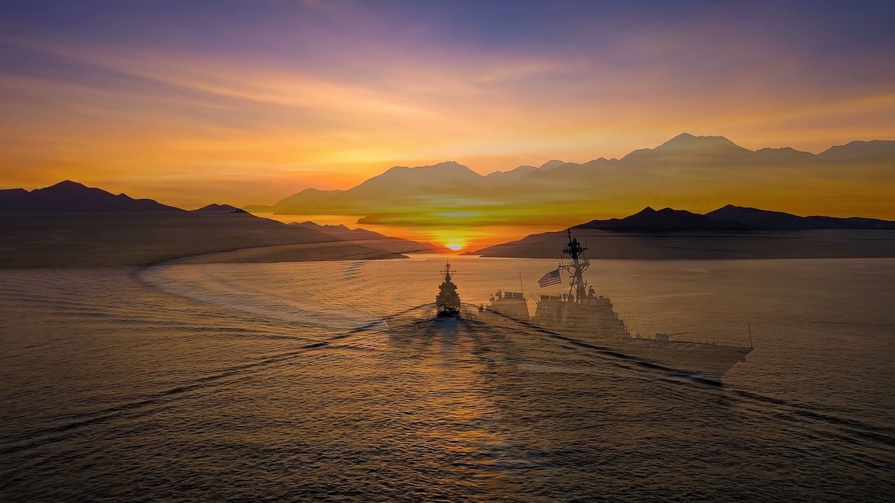 Warship sailing into sunset