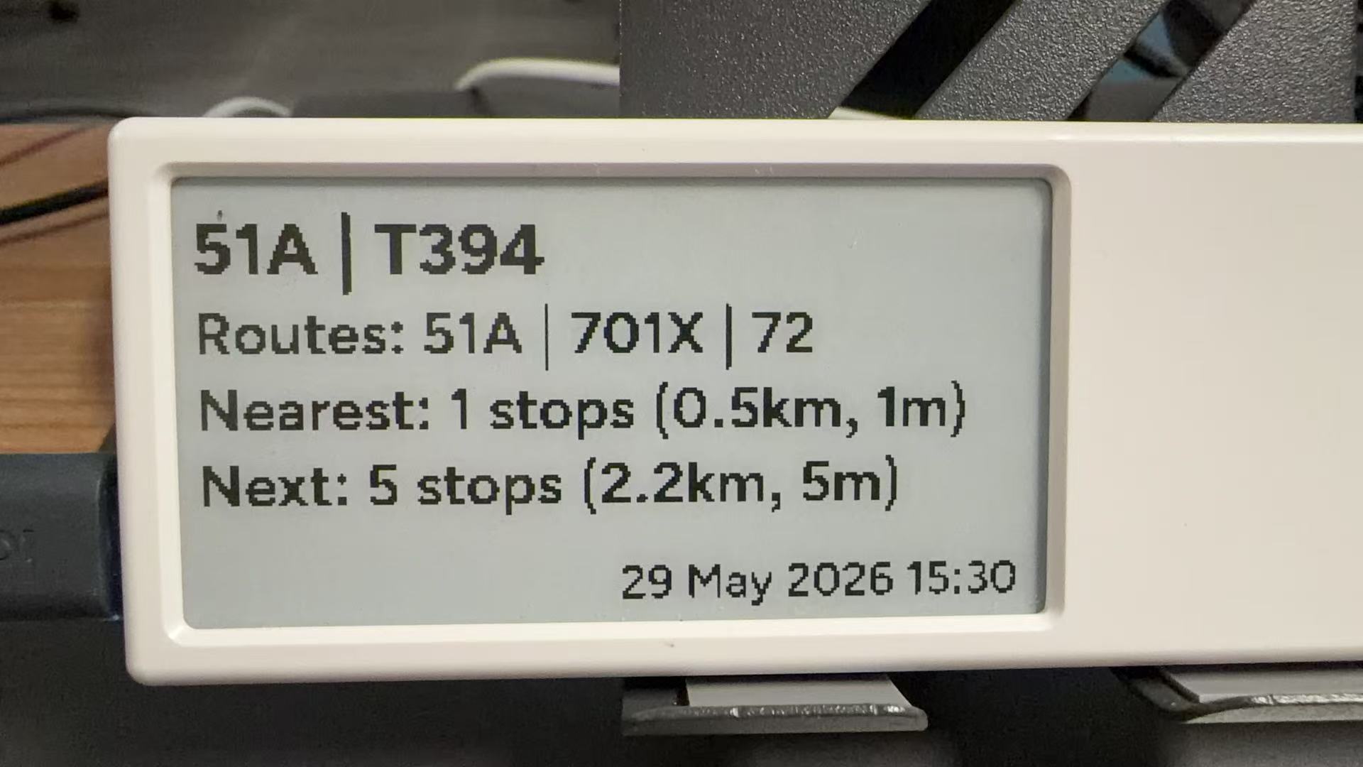 A wall-mounted Quote/0 displaying Macau bus arrival information