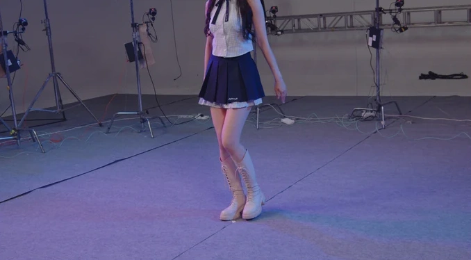 Scene 3: performer in a purple-lit studio, short-focus view