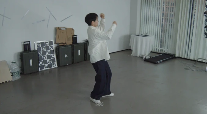 Scene 5: performer in a white studio, short-focus view