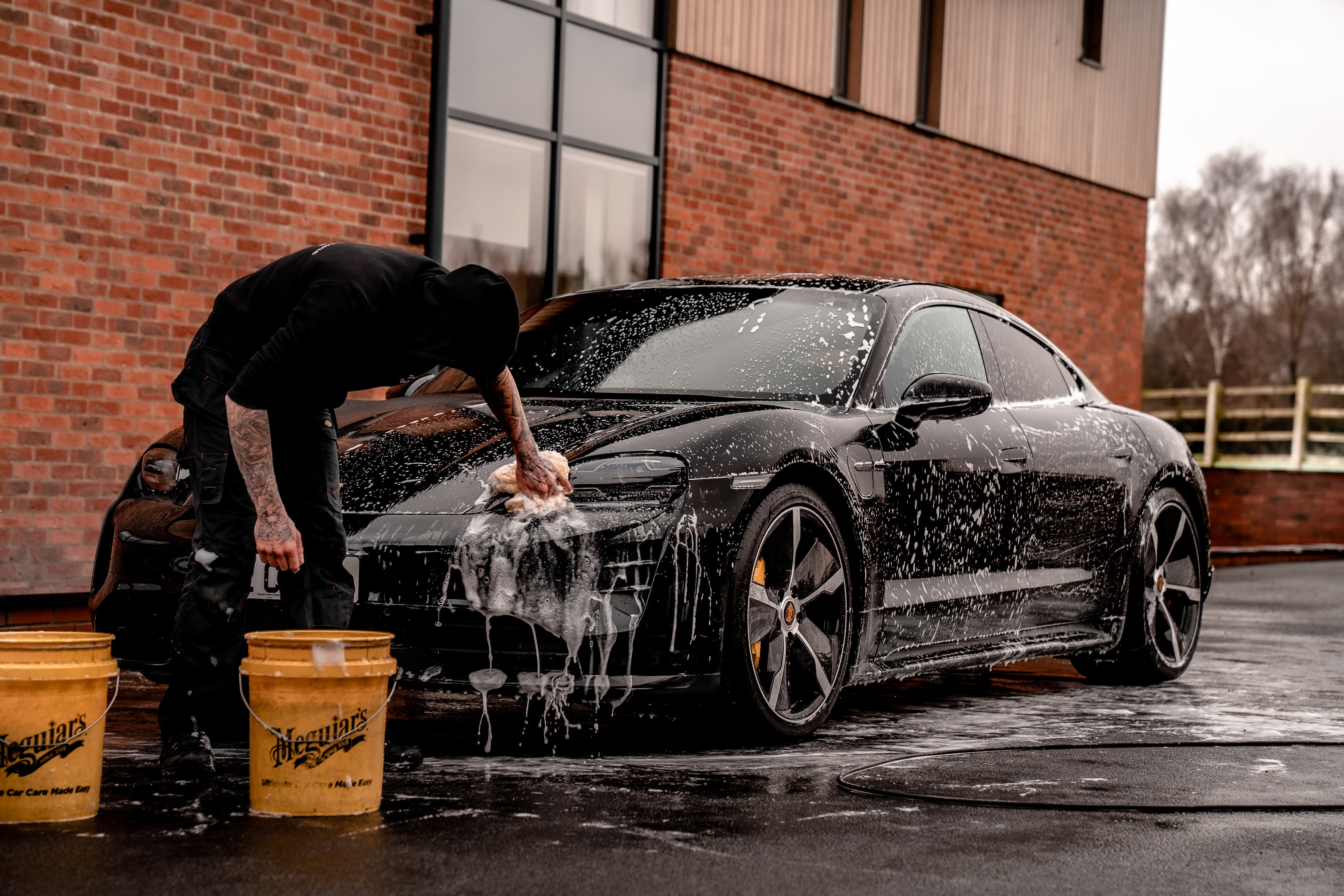 Guy washing a porsche