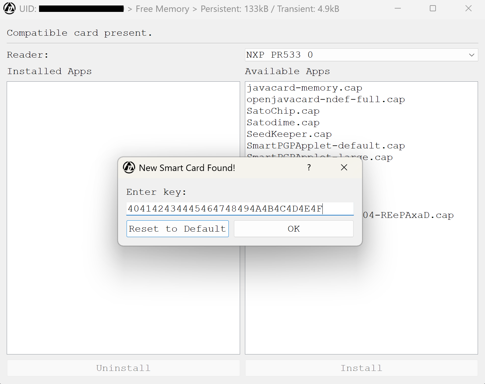 The PC application shows a dialog box stating that a new smartcard has been found and to enter the key displayed over the main window