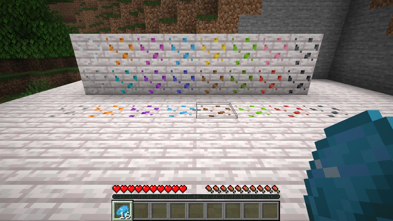 A wall with one dyed resin clump of every colour, and a row of clumps on the floor