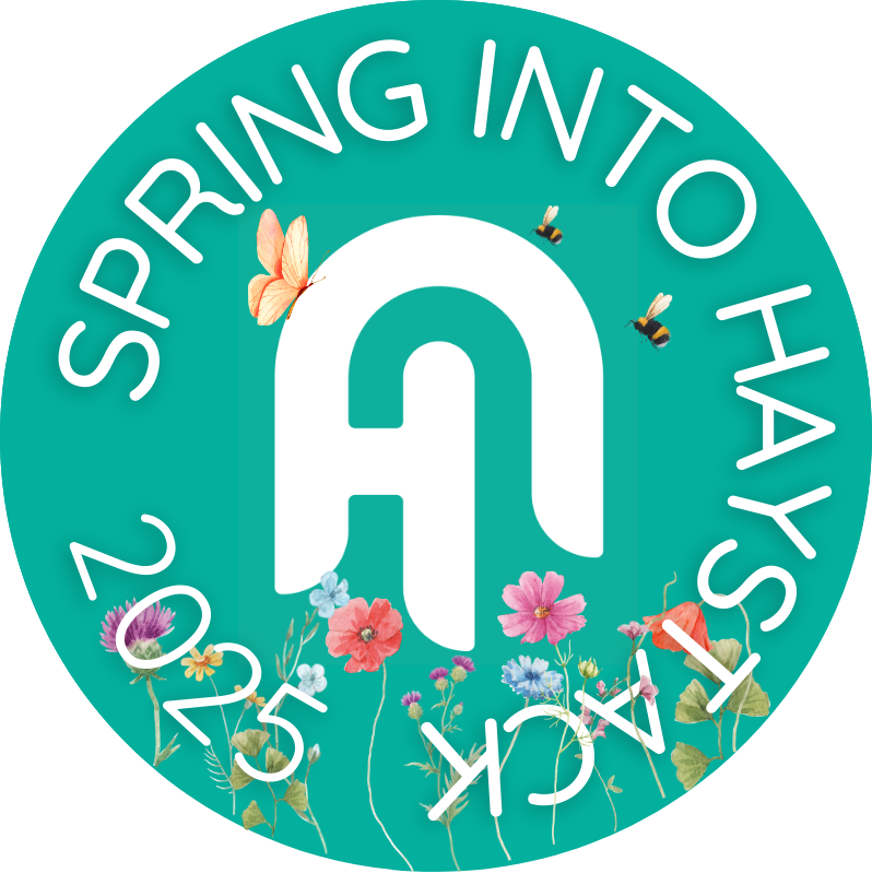 Spring into haystack logo with flowers, bee and butterfly on the logo, giving spring vibes