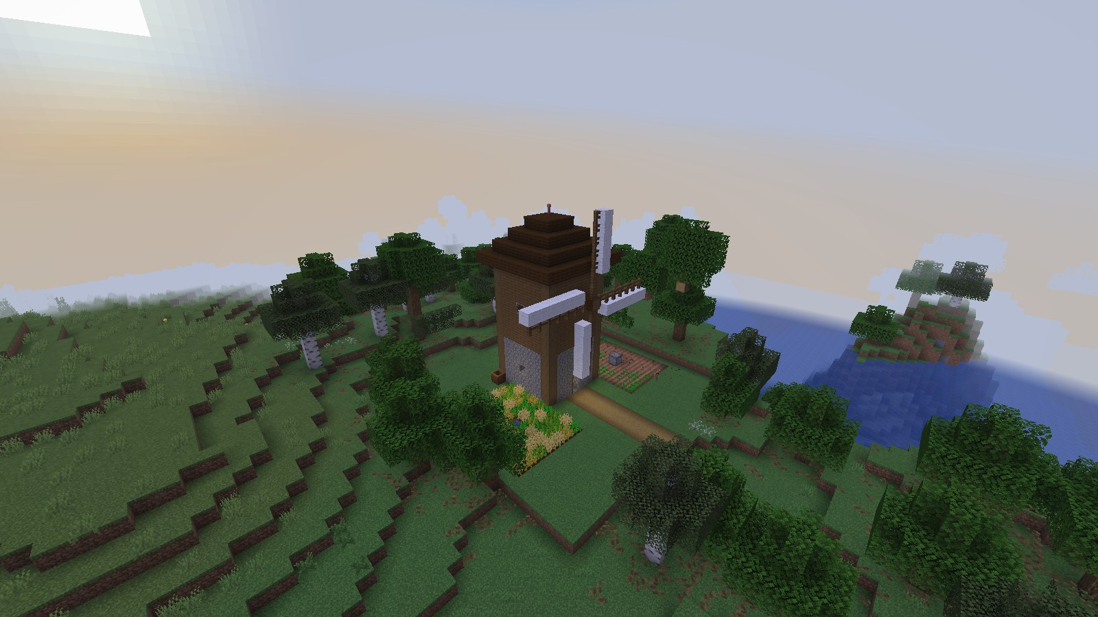 A windmill farmstead on a grassy hill