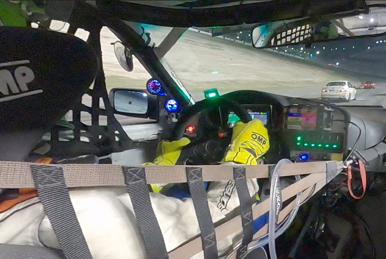 In-car view of Ben Baker driving the Silent Racing BMW E36 on the Daytona road course at night