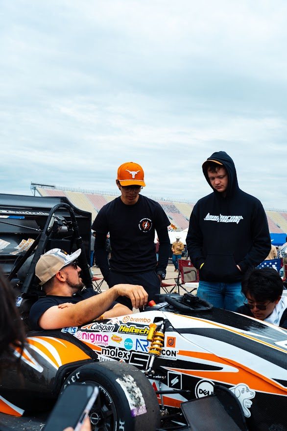 Formula SAE team members examining the car at Michigan International Speedway