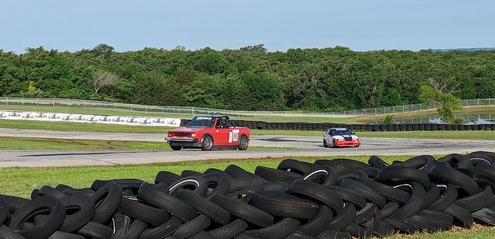 1989 Volkswagen Cabriolet racing on track with a red and white livery