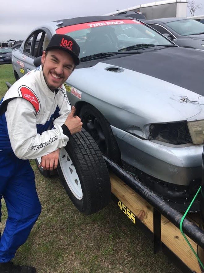 Ben giving a thumbs up next to the Silent Racing SN95 Mustang on a trailer