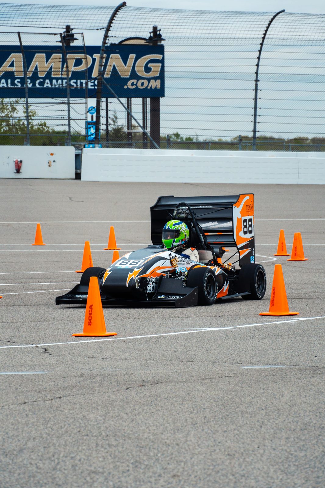 Longhorn Racing Formula SAE car navigating cones at Michigan International Speedway autocross