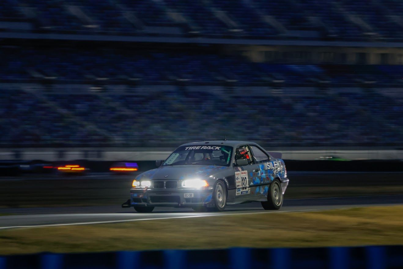 Silent Racing BMW E36 on track at night with headlights on