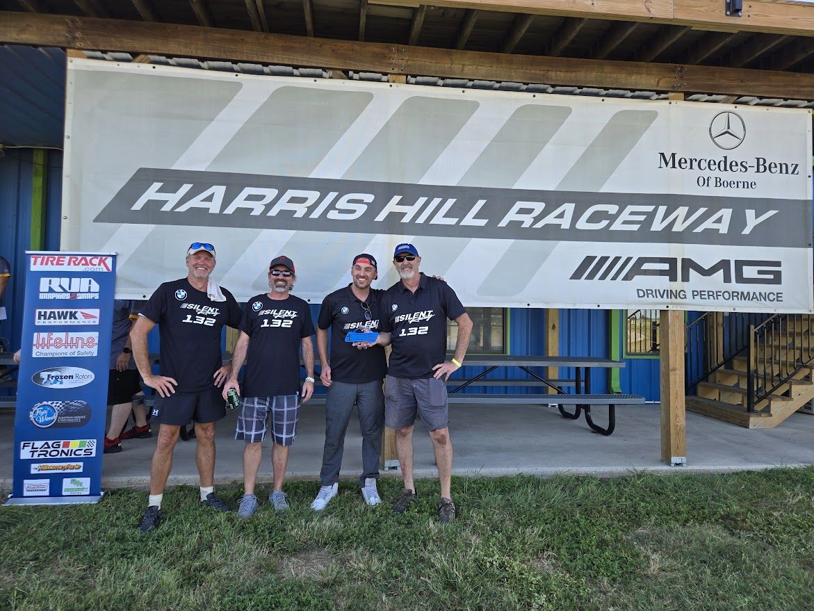 Silent Racing team celebrating with a trophy at Harris Hill Raceway