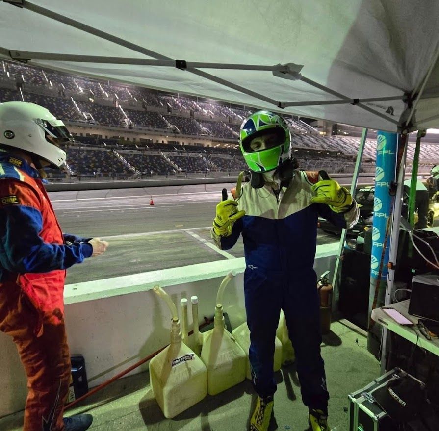 Ben giving a thumbs up in pit lane during a night endurance stint