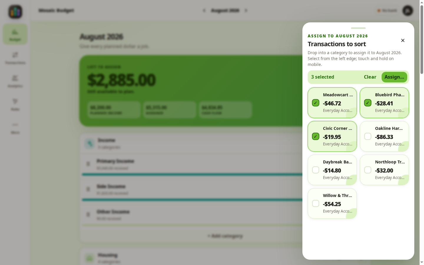 Mosaic Budget transaction sorting tray with several transaction bubbles selected for categorization