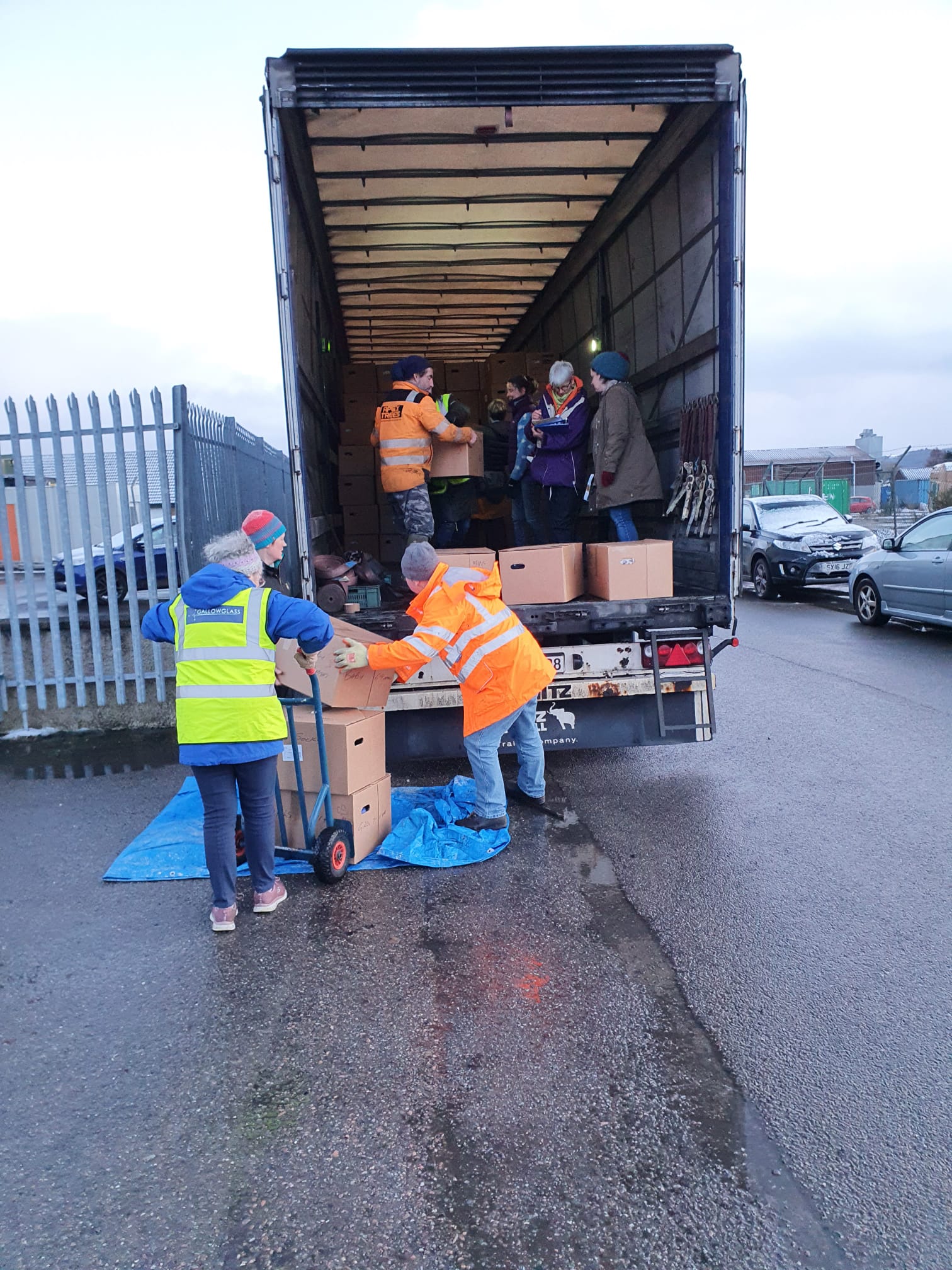 volunteers loading a truck of boxes of aid items