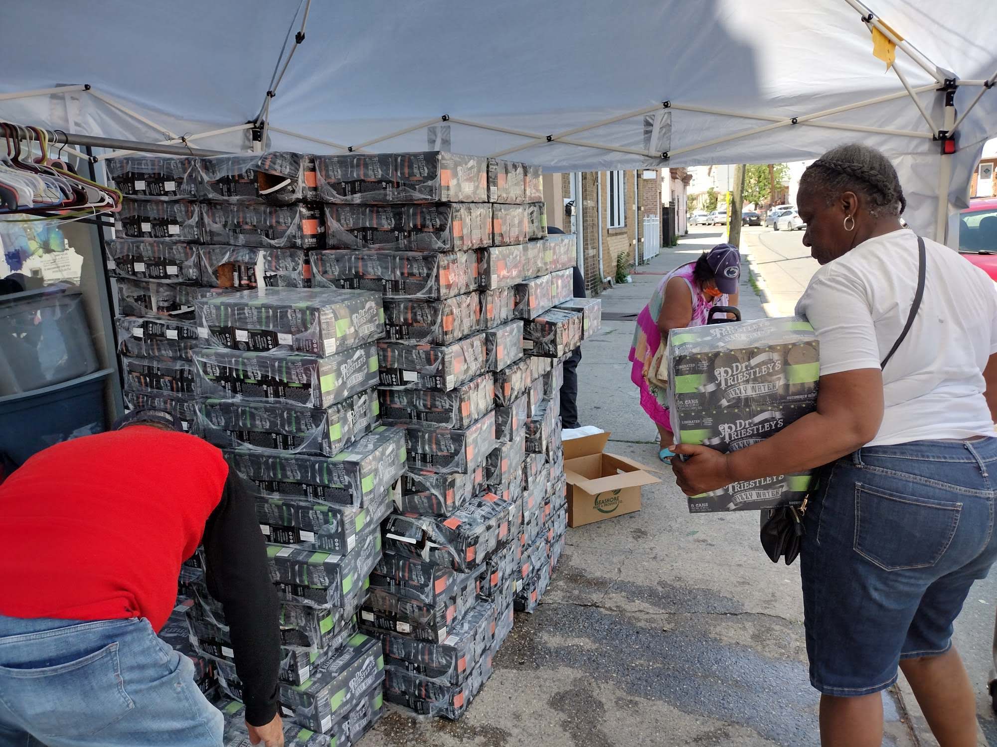 volunteers stacking donations of water