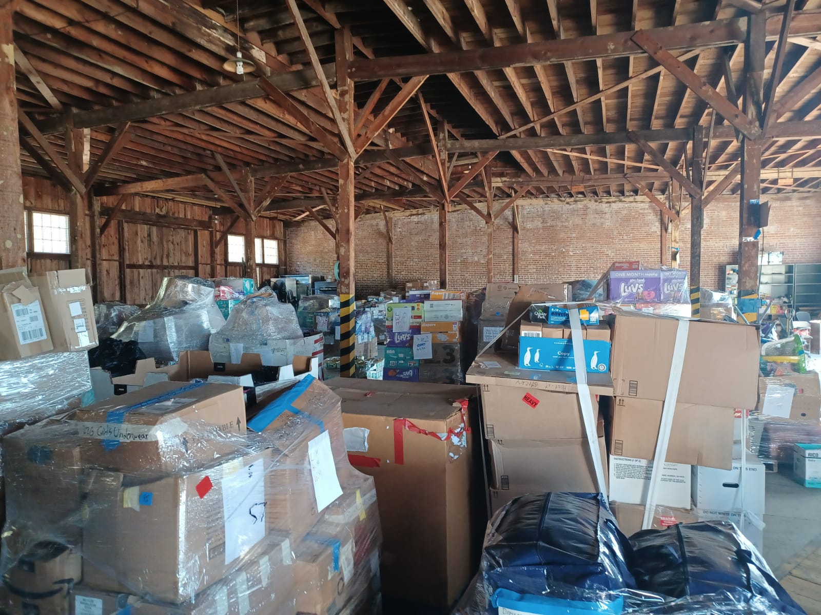 a warehouse filled with lots of boxes of donations