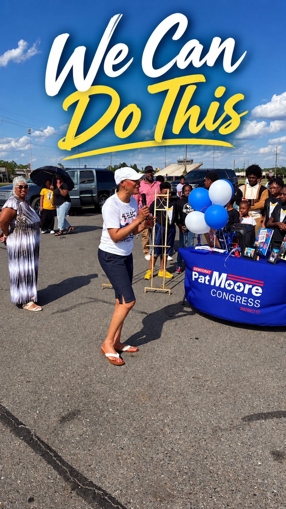 Graphic reading "We Can Do This" over a photo of Pat Moore speaking into a microphone at an outdoor community event, next to a Pat Moore for Congress campaign table with blue and white balloons and community members gathered nearby.