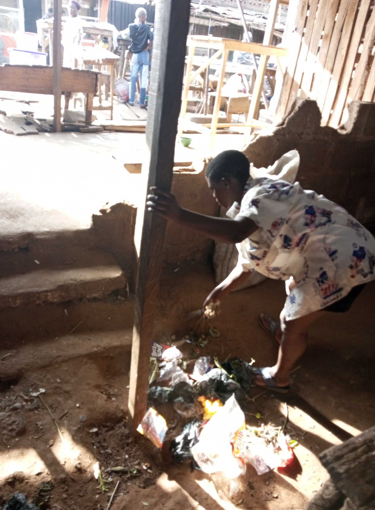 Traders sweeping and sorting waste at Ketu market