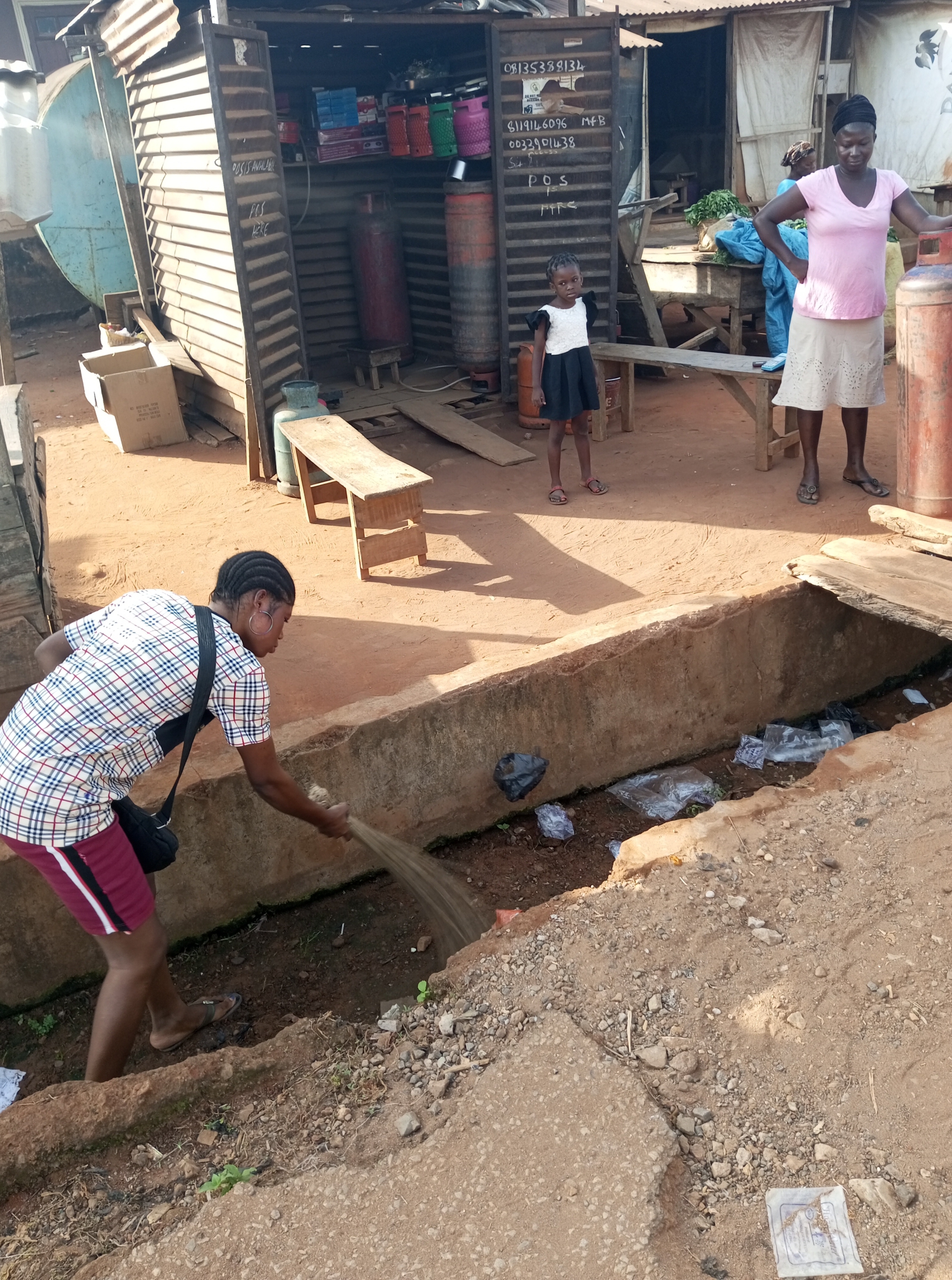 Traders sweeping and sorting waste at Ketu market