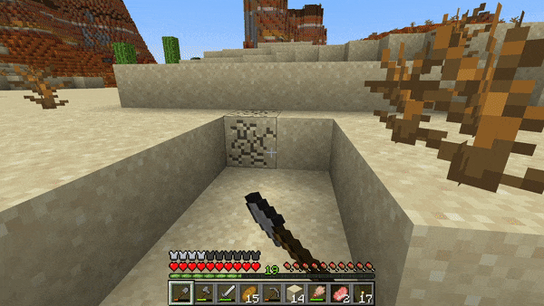 Minecraft player digs sand and finds a barrel with treasure inside