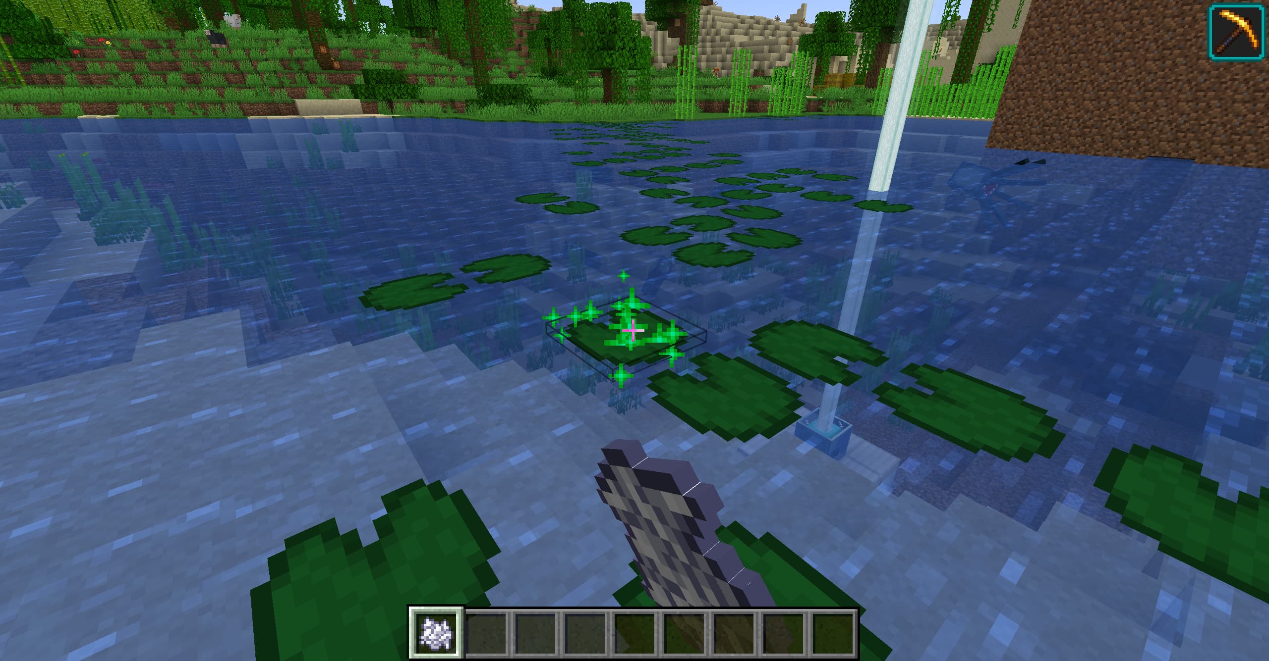 Player using bonemeal on lily pad to grow lily pad