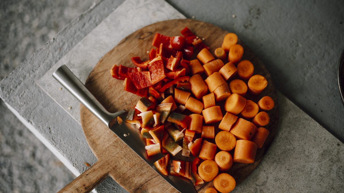 Freshly chopped vegetables spread across a wooden cutting board
