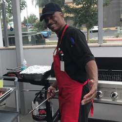 darryl cooking with a pair of tongs