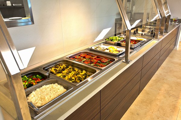 a line of trays buffet style with food