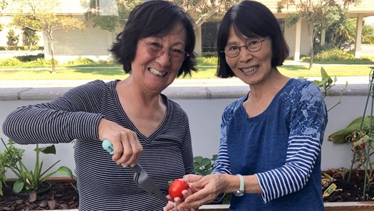 a pair of senior women outside smiling