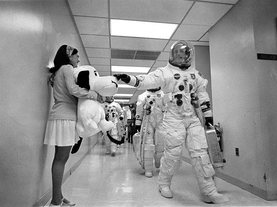 Apollo 10 astronaut Thomas P. Stafford pats the nose of a stuffed Snoopy