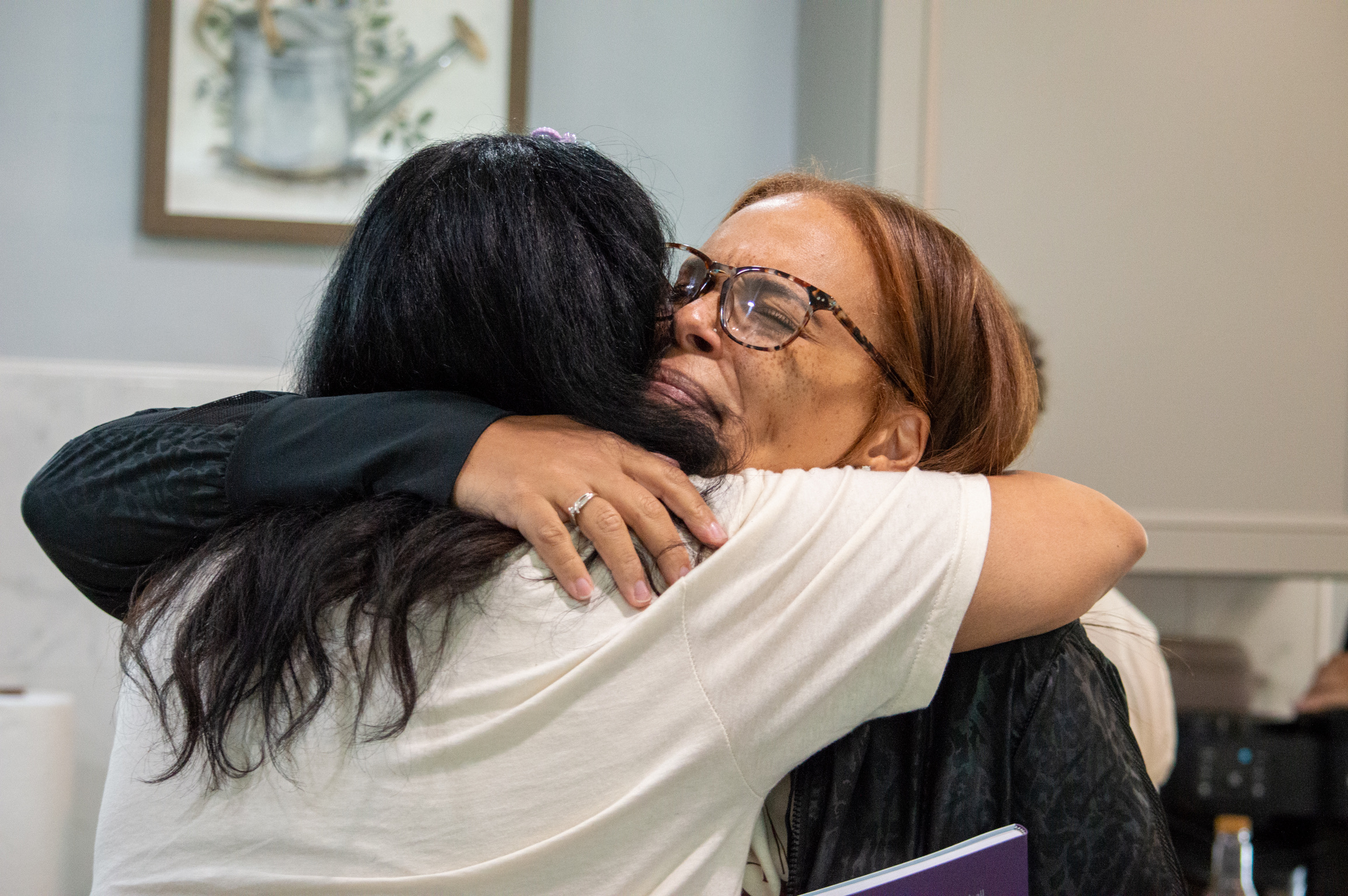 Two women in a tearful, heartfelt hug
