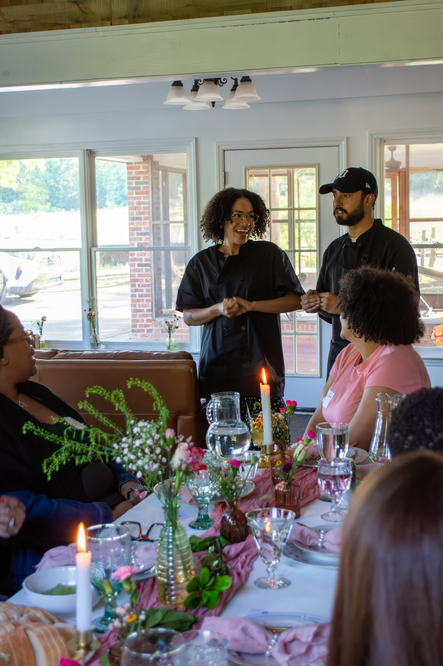 The chefs greeting women gathered at the dinner table