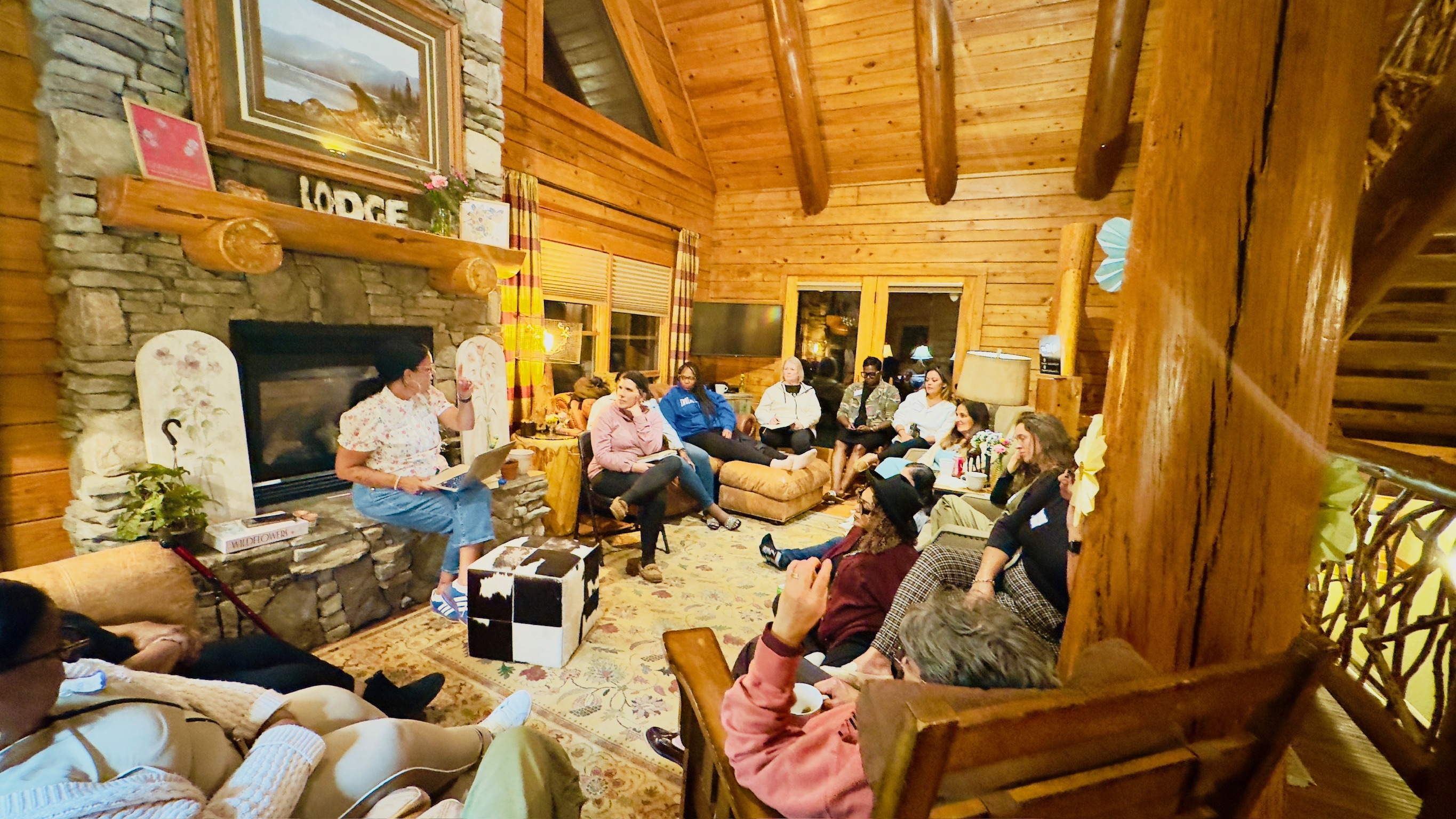 Women gathered around the fireplace for a session in the lodge